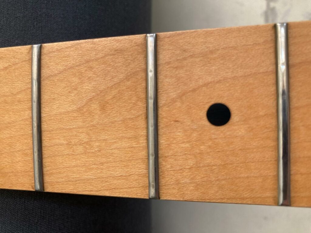 worn frets on a guitar neck